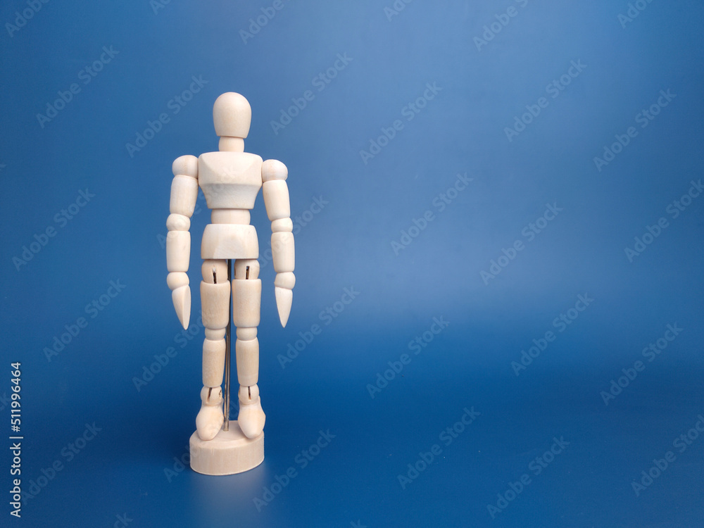 Wooden mannequin in action on a blue background with copy space. Wooden mannequin in action on a blue background with copy space.