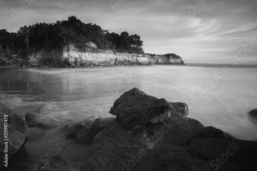 long exposure photo of a beach, a beach with steep cliffs in Indonesia and moving waves