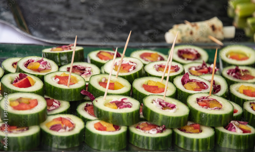filled cucumber slices on a steel plate