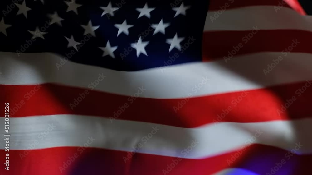 Video of police flasher light shines through the American flag waving on the wind. Video of police flasher light shines through the American flag waving on the wind.