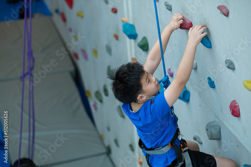 kid climbing a wall, children rock climbing 