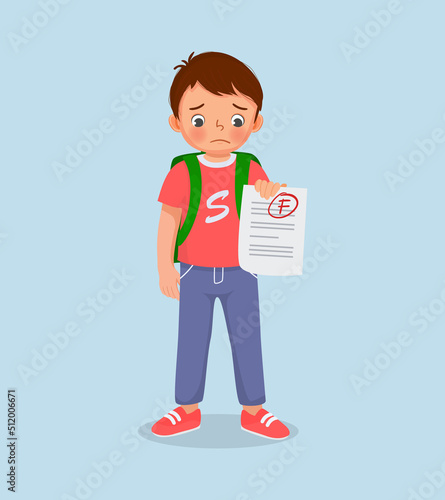 cute little boy feeling sad get bad mark test paper result in exam with low grade score