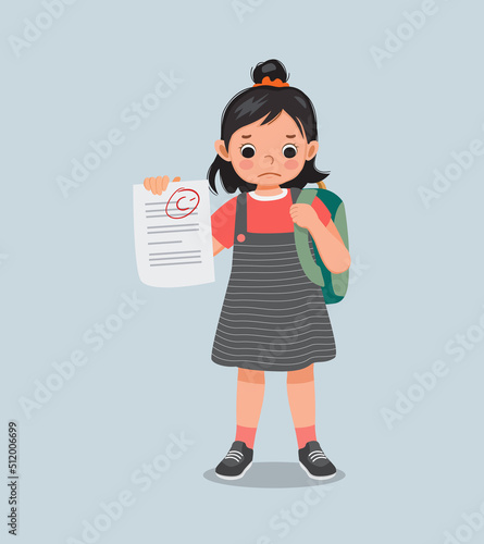 cute little girl feeling sad get bad mark test paper result in exam with low grade score