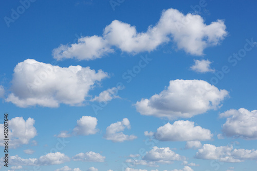 many clouds of different shapes and sizes in the blue sky