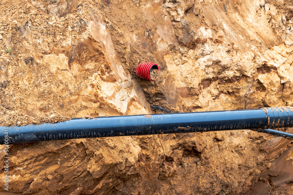 The high voltage electrical cable is laid in a trench under existing engineering sewerage