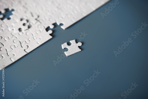 Clean puzzle elements on the red background. Empty puzzle piece on the table. Teamwork concept.