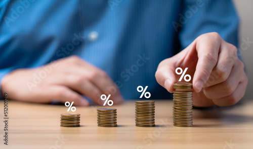 Interest rate and dividend concept. Businessman is calculating income and return on investment as a percentage. Show returns from mutual funds and stocks. long term investment for retirement © Sutthiphong