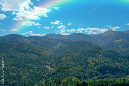 Fototapeta Naklejka Na Ścianę i Meble -  Picturesque mountain landscape and beautiful rainbow in blue sky