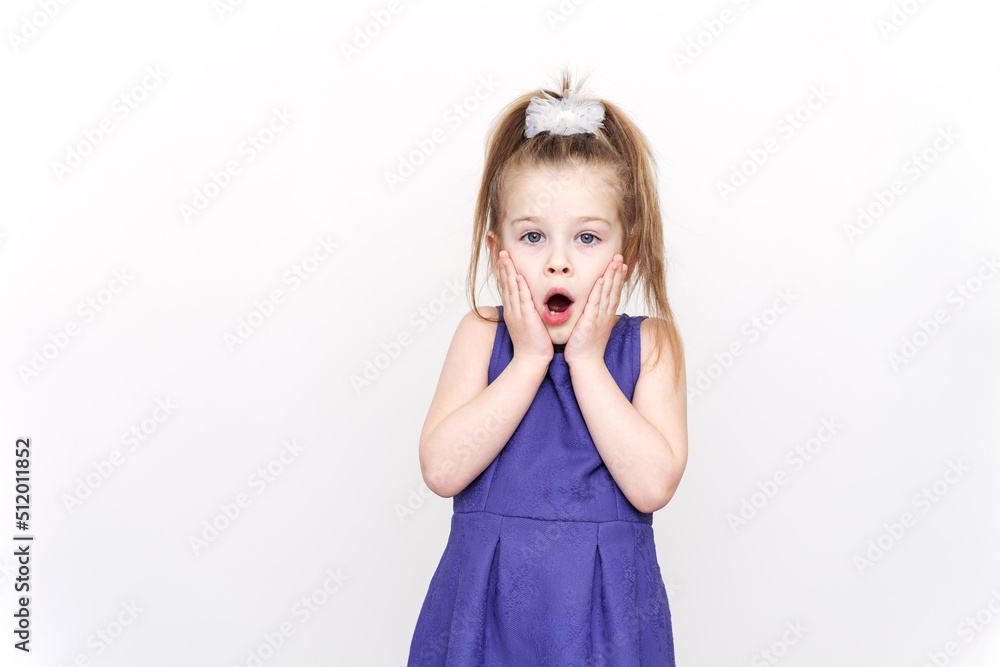emotional surprised 5-6 year old girl in a purple dress. hands near the face, wow effect emotional surprised 5-6 year old girl in a purple dress. hands near the face, wow effect