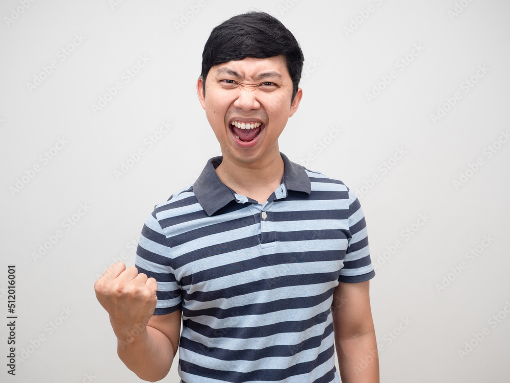 Asian man blue shirt gesture satisfy happy emotion and fist up Asian man blue shirt gesture satisfy happy emotion and fist up