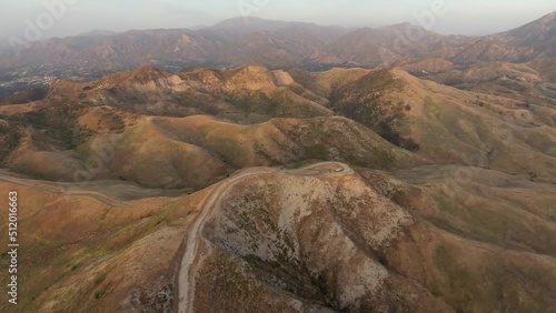 High angle view of Santa Clarita Valley in Southern California, including Forest Service road and distant mountains of Angeles National Forest photo