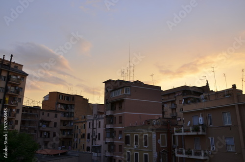 Photos of the sunset over the buildings in Rome