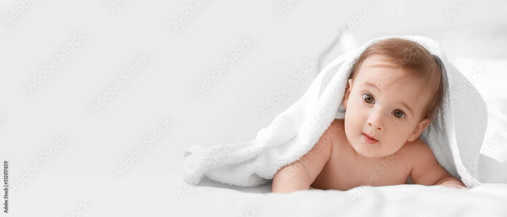 Portrait of adorable baby boy under towel on light background with space for text Portrait of adorable baby boy under towel on light background with space for text