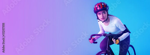 Female cyclist riding bicycle on color background with space for text. Banner for design