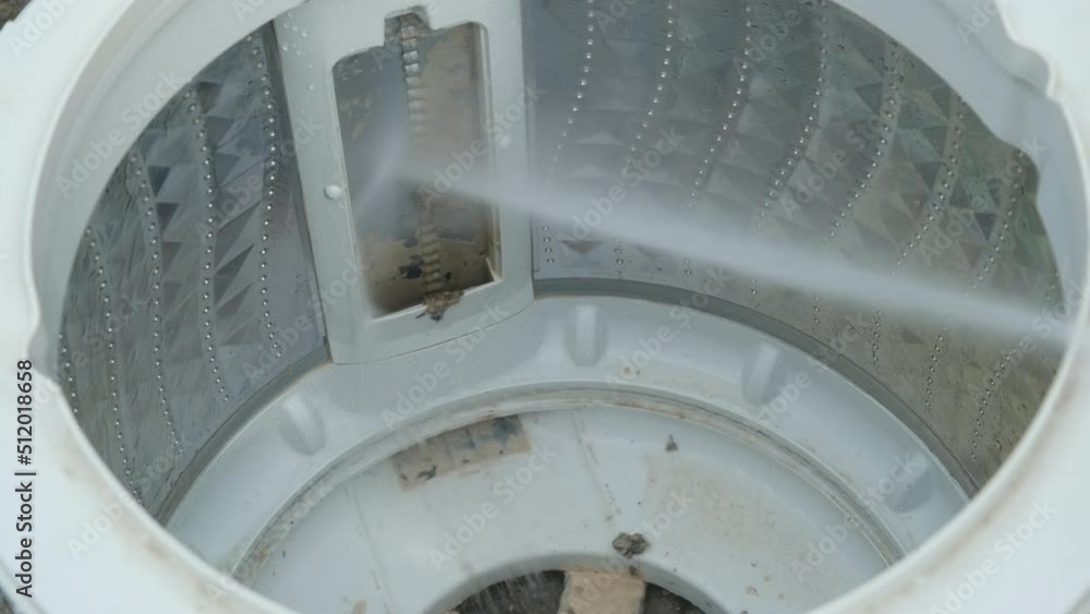Closeup of washing machine drum descaling with highpressure cleaner