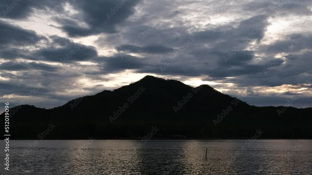 Time lapse of scenery silhouette of mountains and lakes at sunset against cloudy sky. Nature background. Time lapse of scenery silhouette of mountains and lakes at sunset against cloudy sky. Nature background.