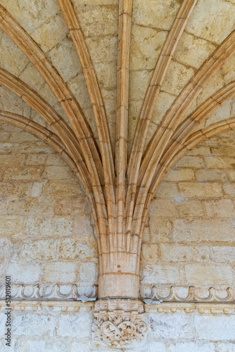 Stone arches extend out of an interior stone wall