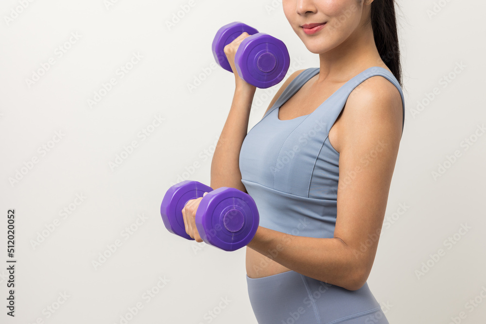 Sporty Asian woman exercises with dumbbells on isolated white background. Good shape and health fitness woman weight training standing pose smile to camera. Sporty Asian woman exercises with dumbbells on isolated white background. Good shape and health fitness woman weight training standing pose smile to camera.