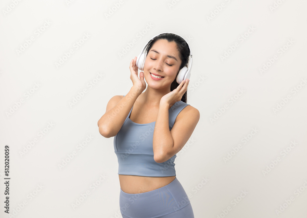 Sexy sporty fitness asian woman with sportswear put on headphone isolated white background. Portrait Good shape and healthy woman standing pose exercise workout in studio. Sexy sporty fitness asian woman with sportswear put on headphone isolated white background. Portrait Good shape and healthy woman standing pose exercise workout in studio.
