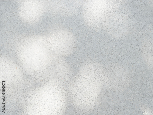Shadow and light from sunlight dappled on flooring marble stone wall texture background.