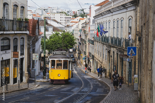 A yellow tram on a Lisbon street in Portugal