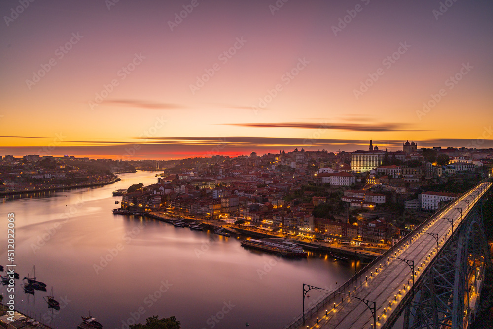 The cityscape of Porto with a bridge in the foreground at sunset and nightfall The cityscape of Porto with a bridge in the foreground at sunset and nightfall