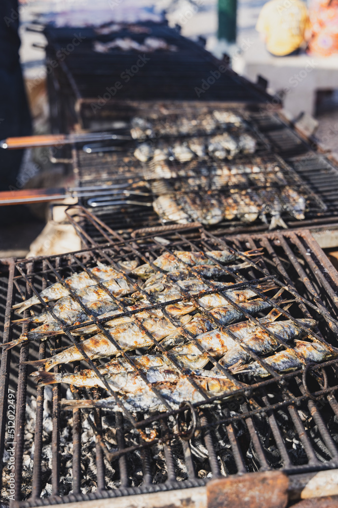 sardines grilling on a charcoal grill during a festival in Lisbon
