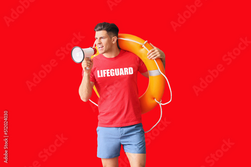 Beach rescuer with lifebuoy and megaphone on red background