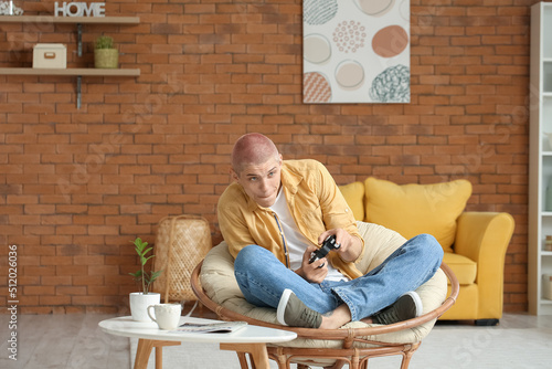 Young guy playing video gam...