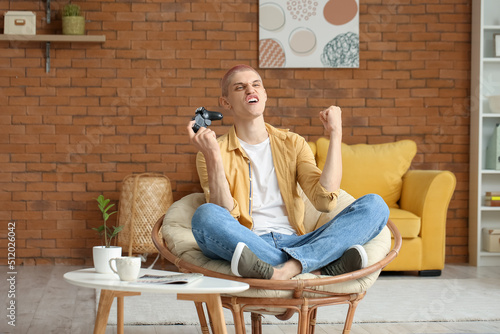 Young guy playing video gam...