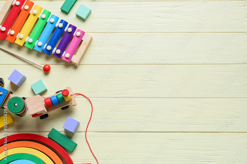 Toy train with building blocks and xylophone on yellow wooden