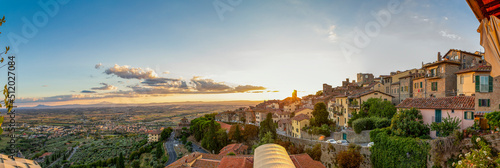 Italy, Province of Arezzo, Cortona, Panoramic view of town overlooking Chiana Valley at sunset photo