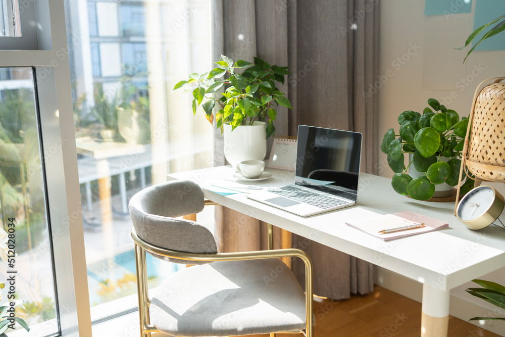 Laptop kept on desk in front of chair at home office Laptop kept on desk in front of chair at home office