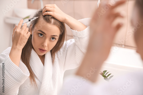 Young woman with hair loss ...