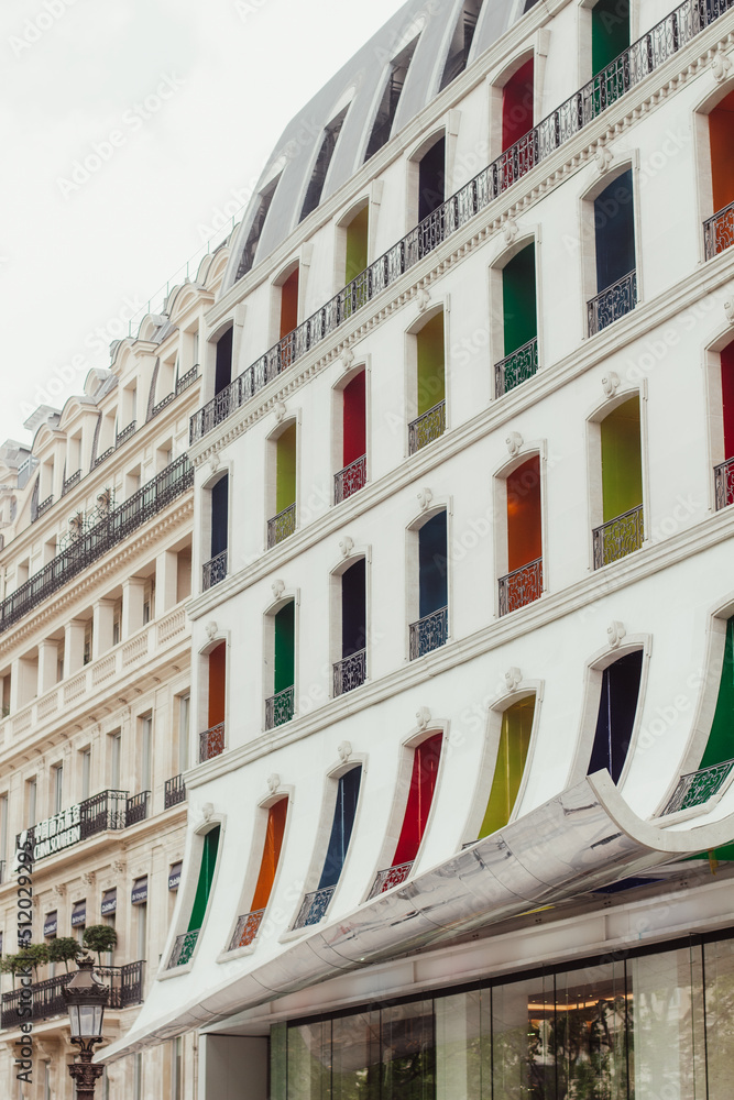 A picture of a white facade with brightly coloured windows