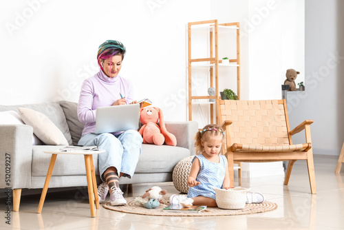 Little girl with toys and h...