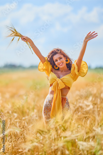 A happy caucasian young and beautiful woman in a field.