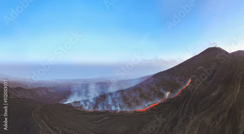 Etna top view  with lava flow and smoke with blue sky during blue hour- Aerial panorama at sunset