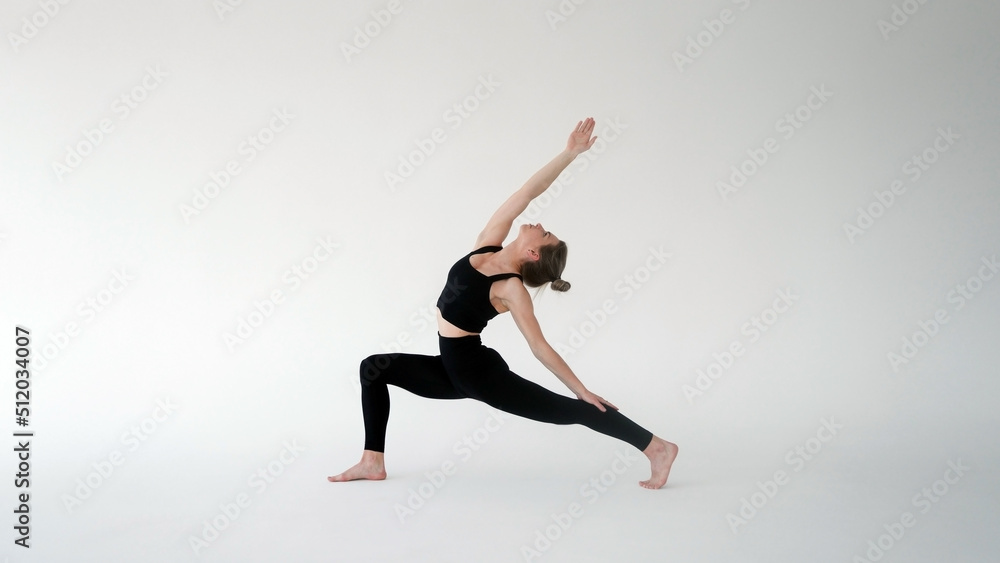 Girl doing exercises, practicing yoga in class. Young woman meditating and doing exercises. Training, workout, fitness, meditation, yoga practice, relaxation at home, healthy lifestyle concept