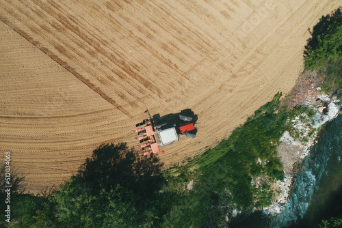Farmer seeding, sowing crops at field. Sowing is the process of planting seeds in the ground. Drone Photo