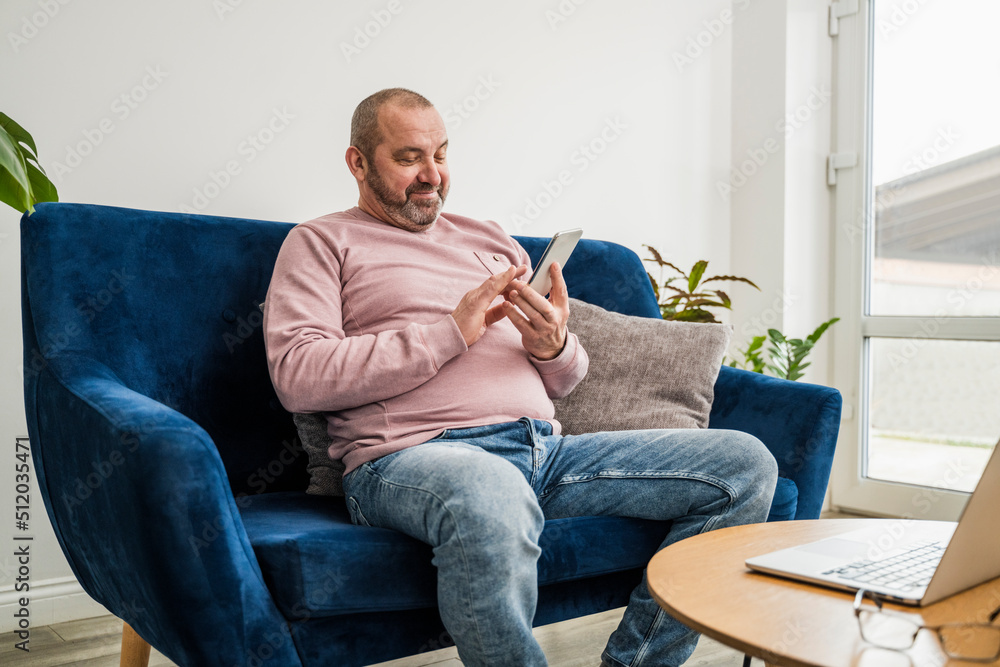 Smiling freelancer using smart phone at home Smiling freelancer using smart phone at home