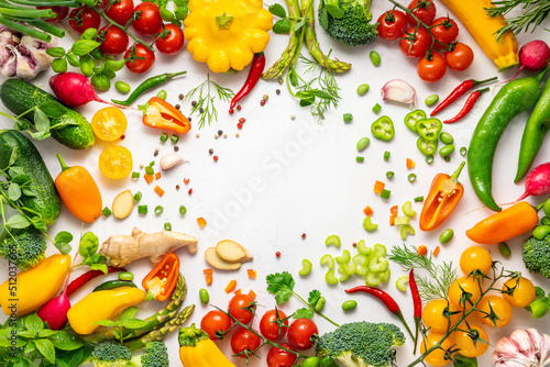 Fresh assorted vegetables and herbs on white background. Healthy clean eating, vegetarian or diet food concept.Food frame.
