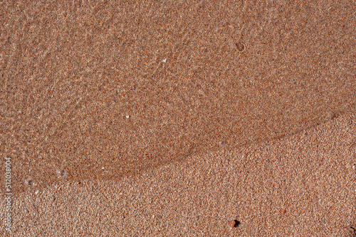Soft sea wave on the sand beach, top view
