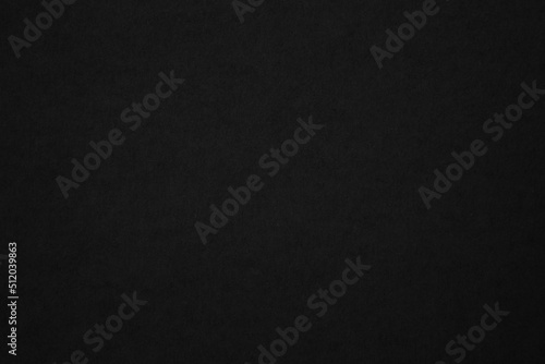 Black paper texture background. Black blank cardboard sheet page. Old vintage page dark grunge vignette.