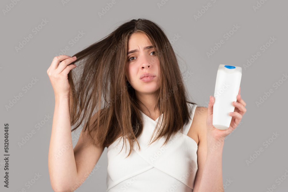 Woman hand holding bootle shampoo with serious hair loss problem for health care shampoo. Woman hand holding bootle shampoo with serious hair loss problem for health care shampoo.