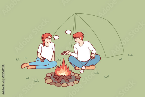 Happy man and woman sitting near campfire in forest. Smiling couple relax at wood camp near fire together. Nature recreation concept. Vector illustration. 