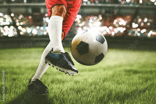 Fototapeta Naklejka Na Ścianę i Meble -  Soccer player feet shooting a ball in the stadium