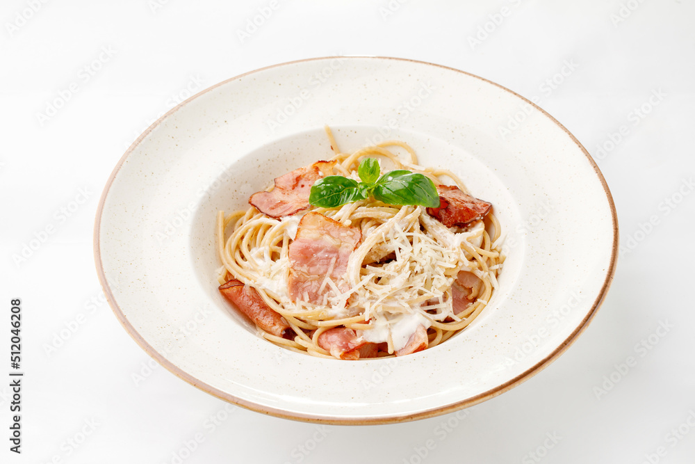 Pasta with parmesan bacon and white sauce on a white background Pasta with parmesan bacon and white sauce on a white background