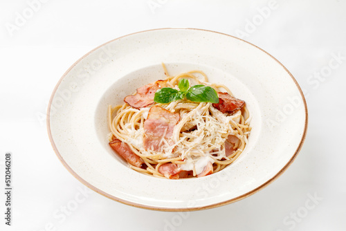 Pasta with parmesan bacon and white sauce on a white background