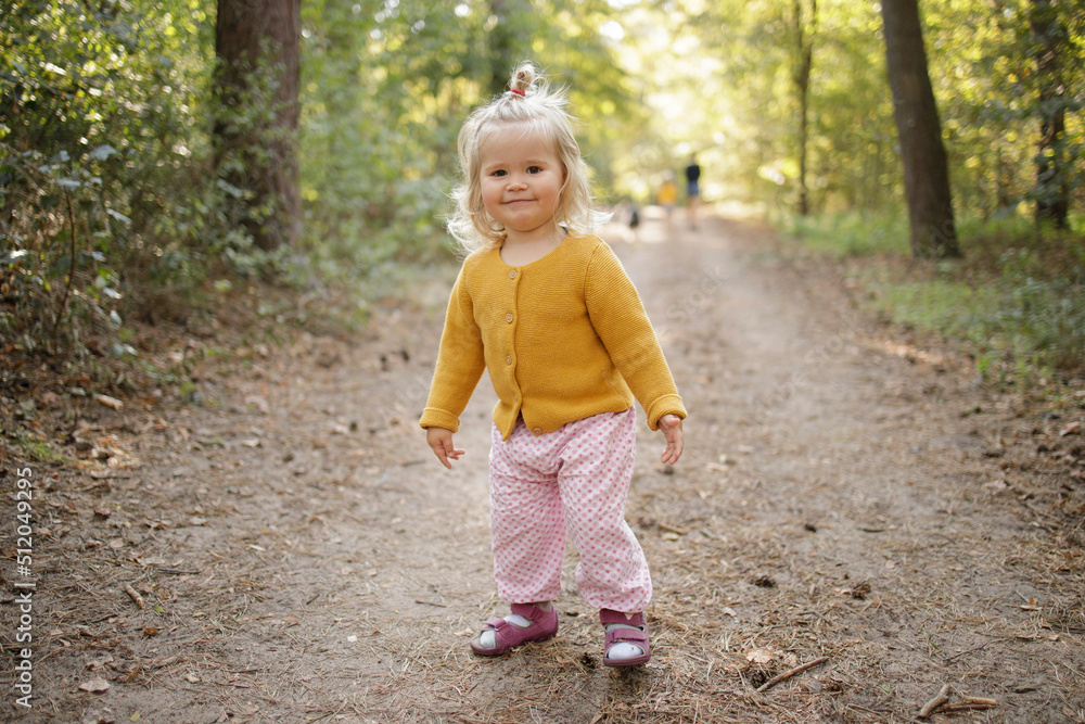Smiling cute blond girl on footpath in forest Smiling cute blond girl on footpath in forest